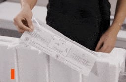 Looping video of someone removing the paper guide from TV packaging